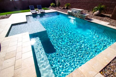 Back Yard With Two Lounge Chairs And Swimming Pool