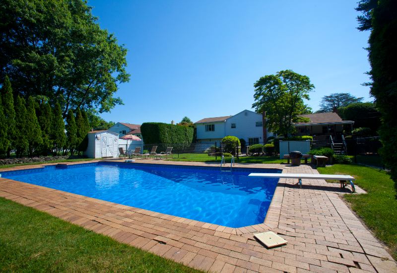 Newly constructed in‑ground swimming pool in a landscaped residential yard in Phoenix, AZ